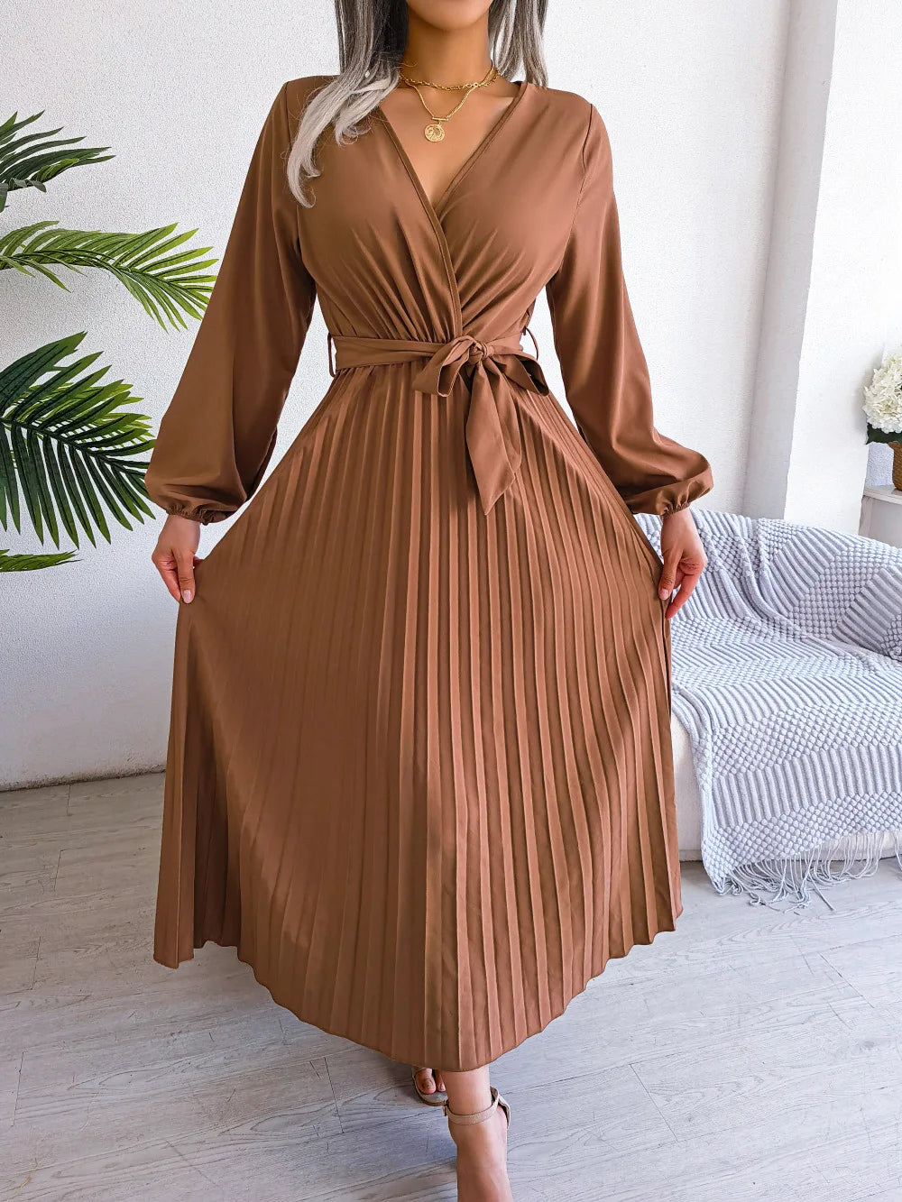 Elegant V-neck pleated maxi dress with long sleeves.