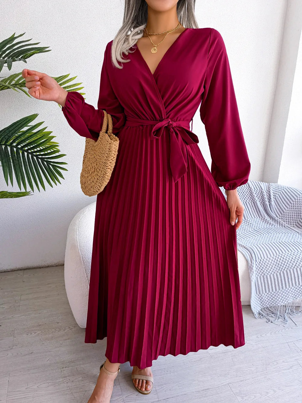 Elegant V-neck pleated maxi dress with long sleeves.