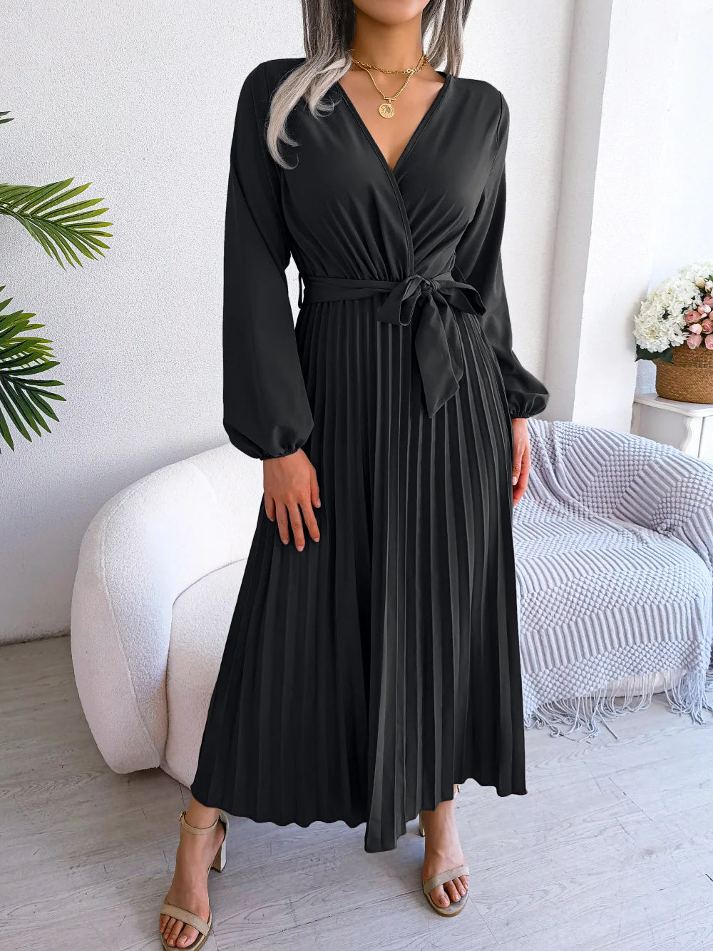 Elegant V-neck pleated maxi dress with long sleeves.