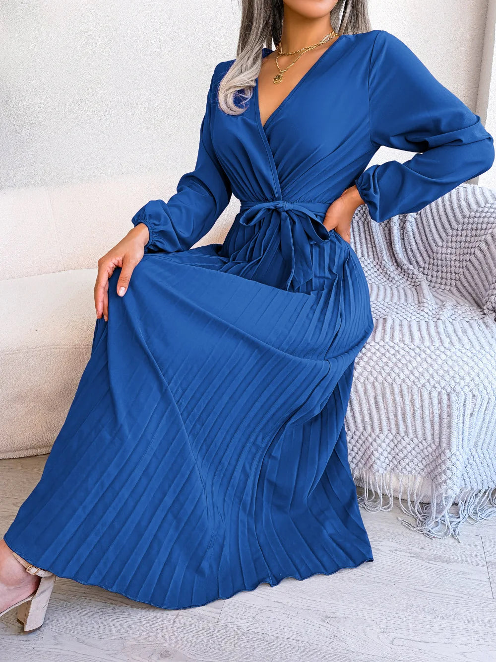 Elegant V-neck pleated maxi dress with long sleeves.