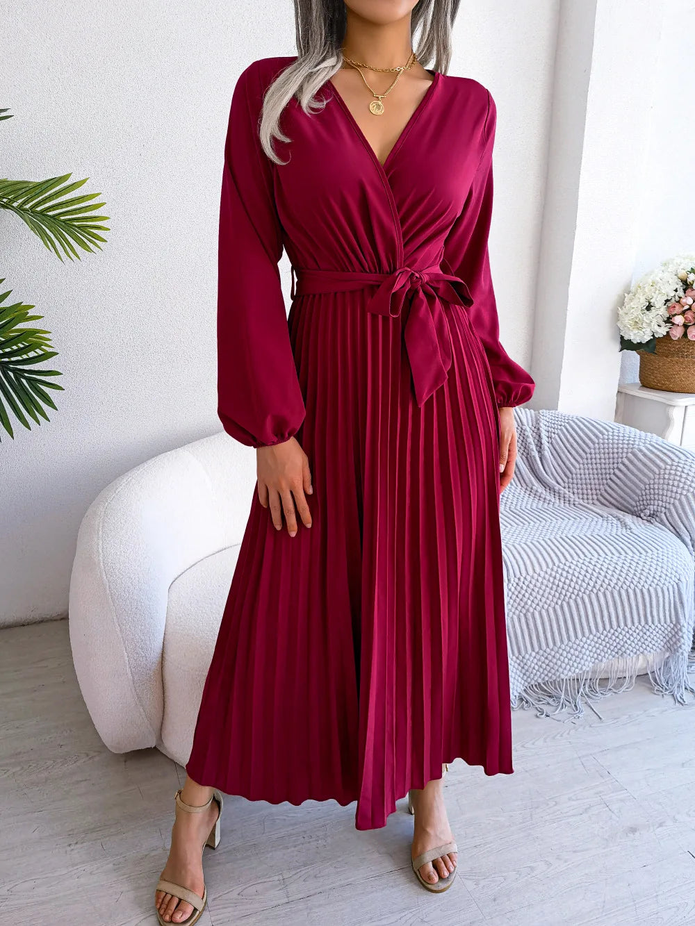 Elegant V-neck pleated maxi dress with long sleeves.